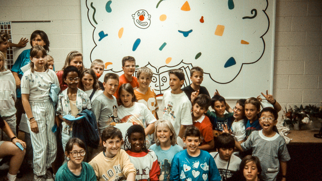 Students posing in front of Keith Haring’s mural in progress at Ernest Horn Elementary School