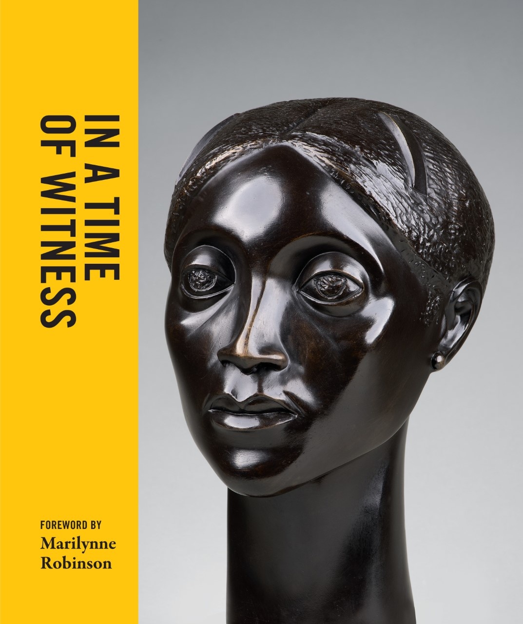 Image of the front cover of "In a Time of Witness." It features a detail shot of Elizabeth Catlett's "Glory," with a yellow sidebar that features the book's title.
