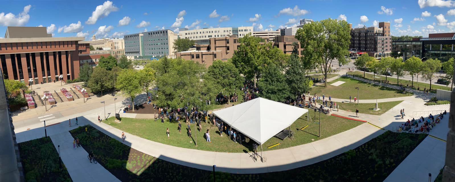 Aerial view of Gibson Square Park with large white tent and big crowd of people