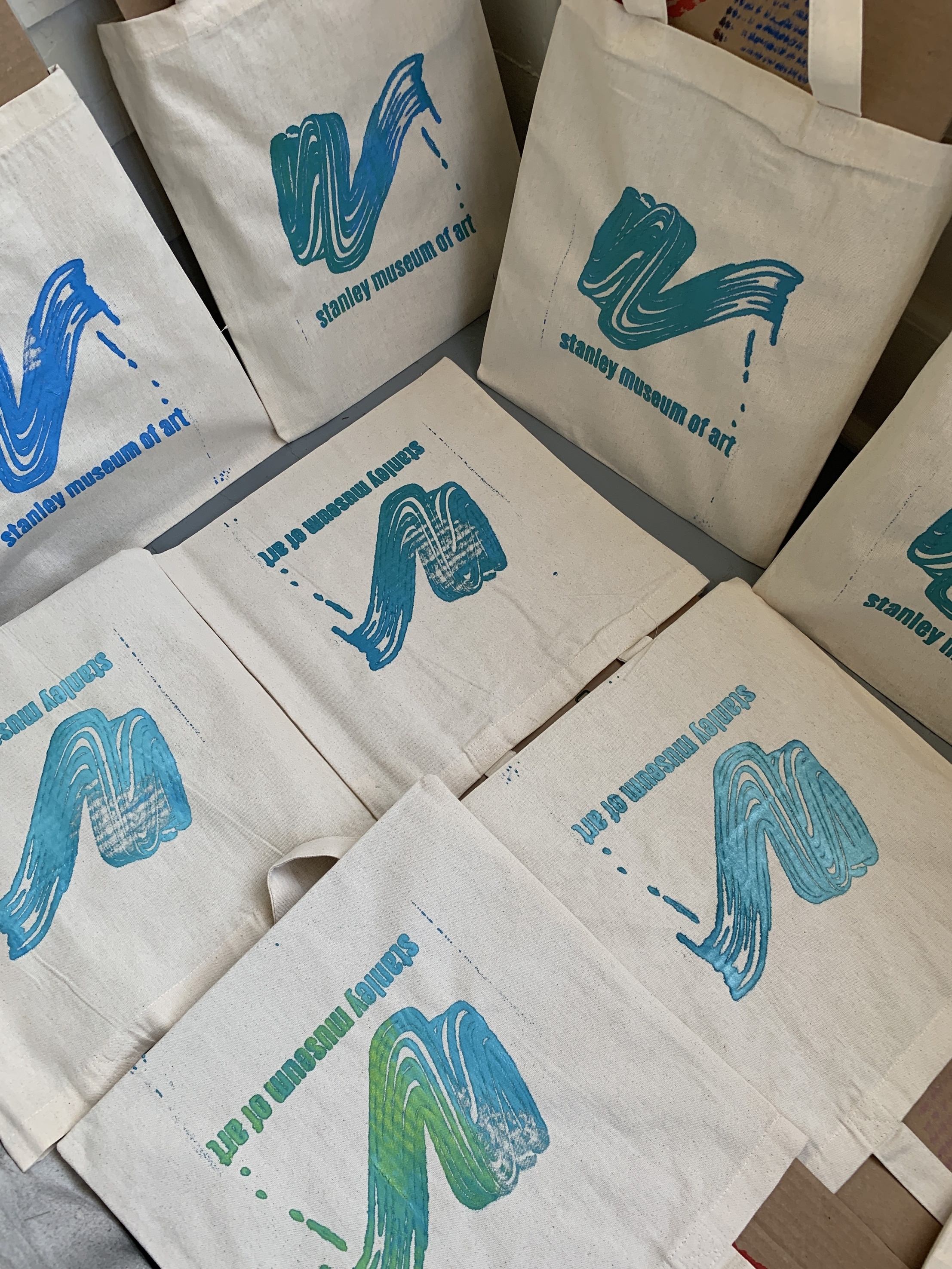Tote bags imprinted with a paint brush swoosh and "Stanley Campus Council"