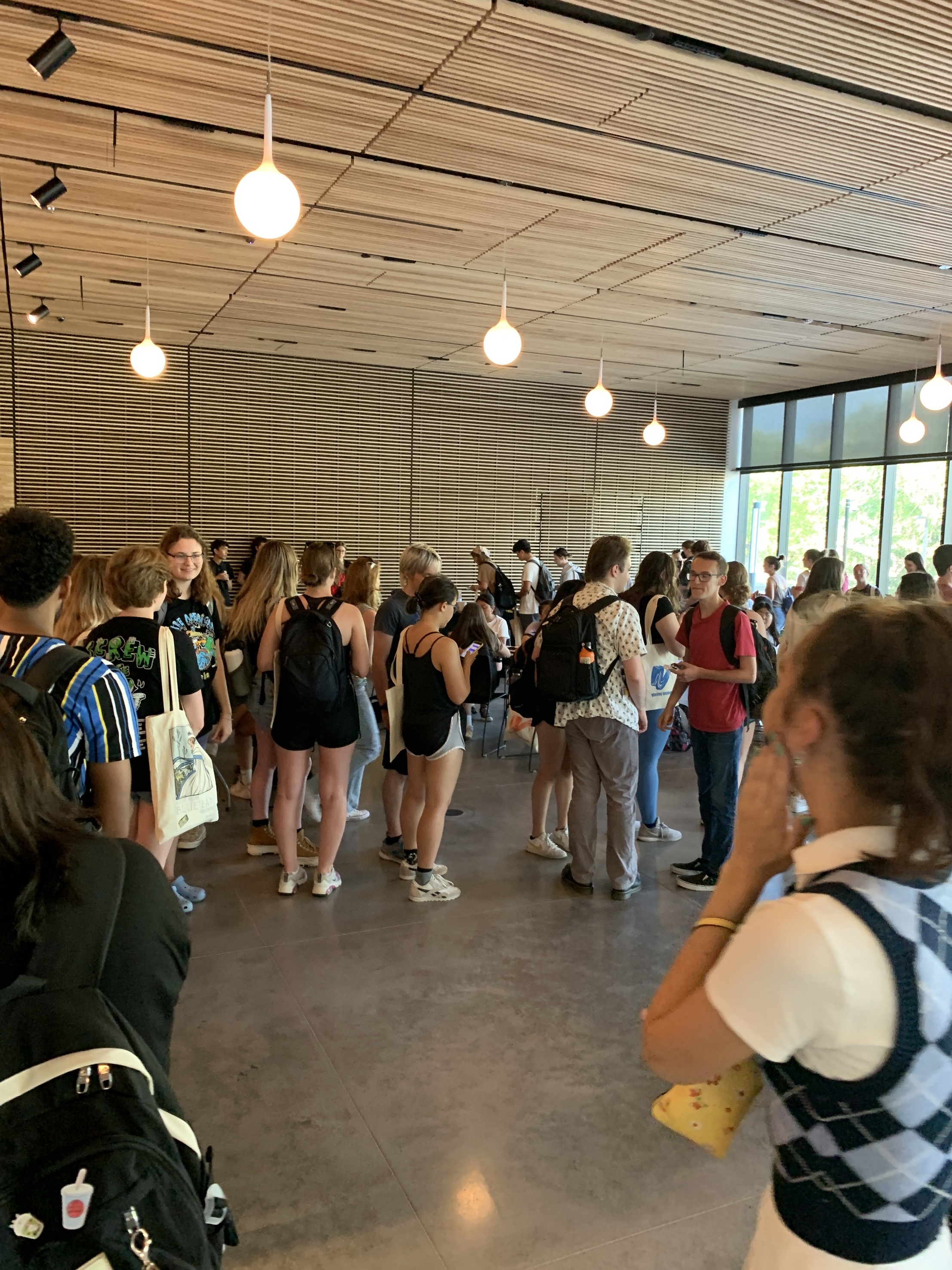 A large group of students in the lobby of a museum
