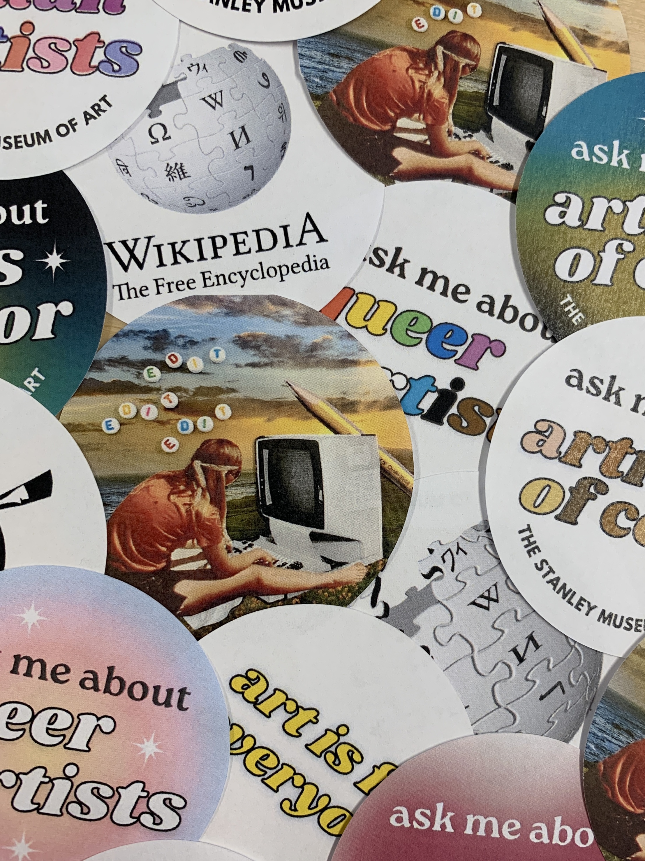 A pile of buttons for the Wikipedia Edit-a-thon with different slogans on them.