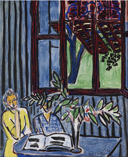In an interior scene, a large window dominates the background. Its blue panes and red frames reveal a view of green foliage outside. The walls feature narrow, vertical blue panels. A blue table stands before the window, supporting a large open book. To the left of the table, a woman in a yellow dress leans on her hand, engrossed in reading. A potted plant with green leaves partially conceals another figure behind the table, dressed in a blue top with darker blue checks.