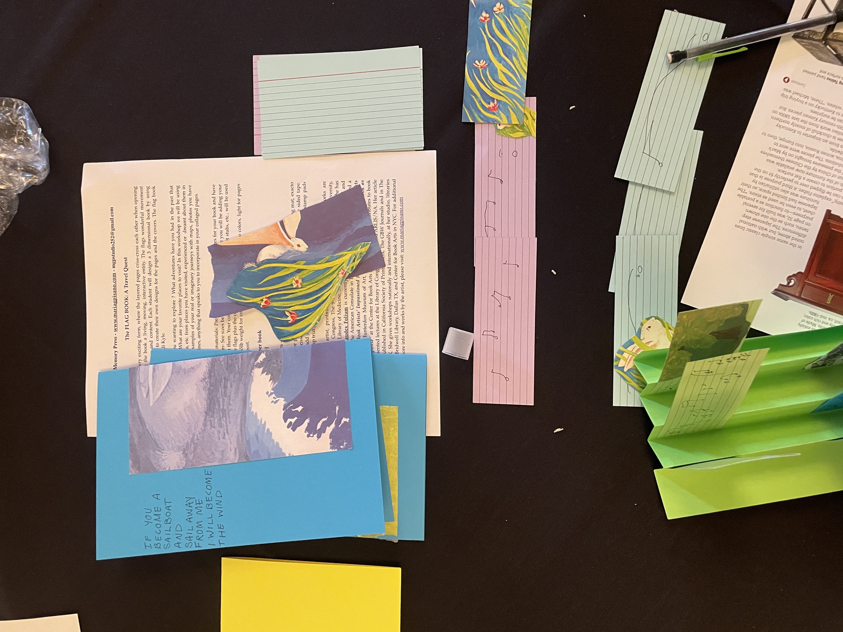 A photograph of the process of making a flag book out of other book materials. 