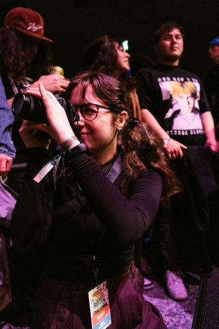 A photo of student Abbie McLaren, holding a camera. 