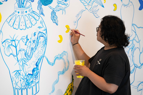 A person painting designs on a wall