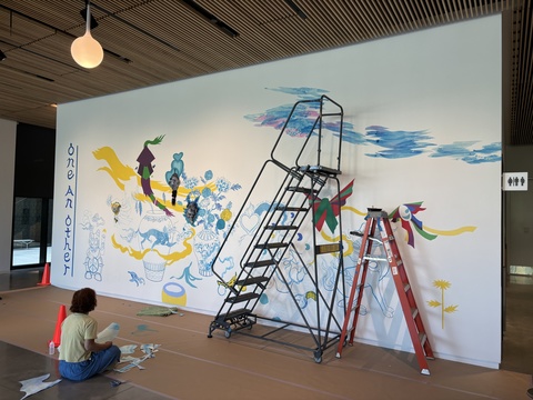 A progress photo of Jiha Moon's "One An Other" mural in the Stanley's lobby.