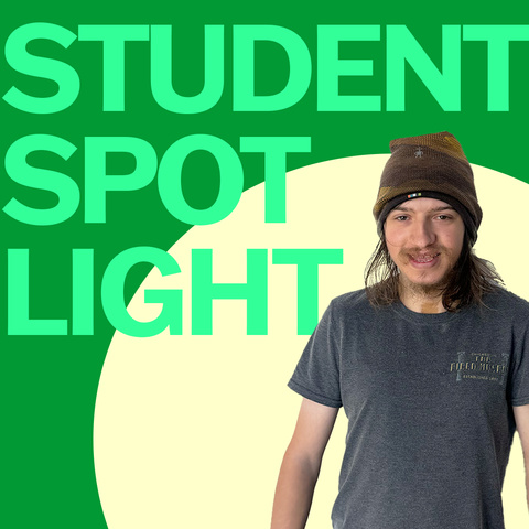 A photo of Luke Krchak superimposed onto a green background, with the words "Student Spotlight." Luke is wearing a brown beanie and a blue t shirt and is smiling.