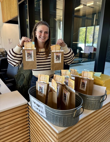 Amelia poses with the activity bags at the front desk.