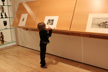 child looking at artwork