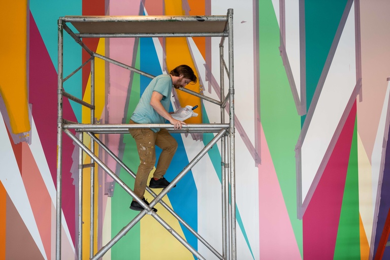Conor Fields positions himself on scaffolding during the installation of "Surrounding."