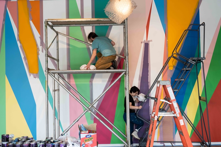 Conor Fields and Jenna Pirello use scaffolding and a ladder to install "Surrounding."
