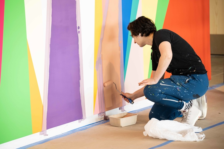 Jenna Pirello applies paint during the installation of "Surrounding."