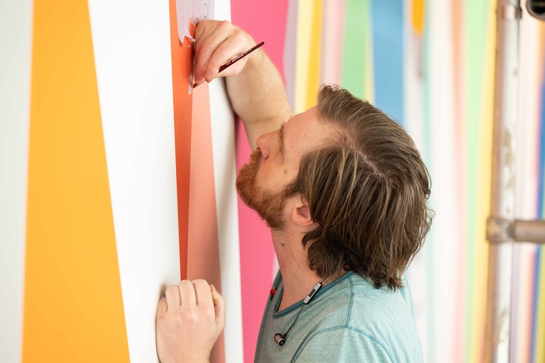 Conor Fields applying paint during installation of "Surrounding."