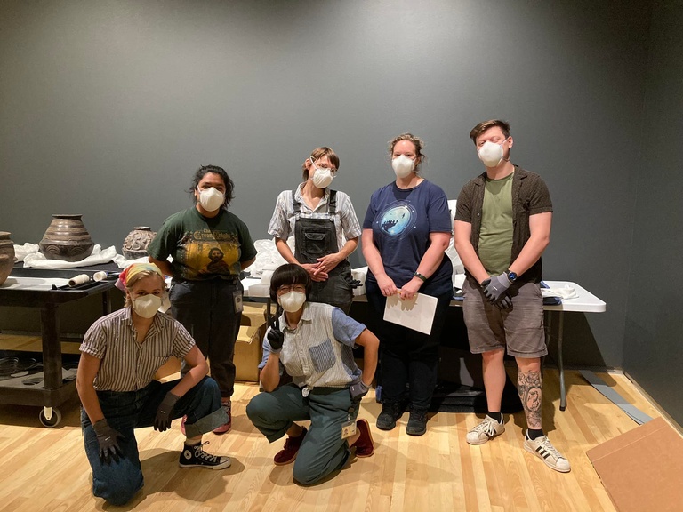Group of art handlers wearing face masks 