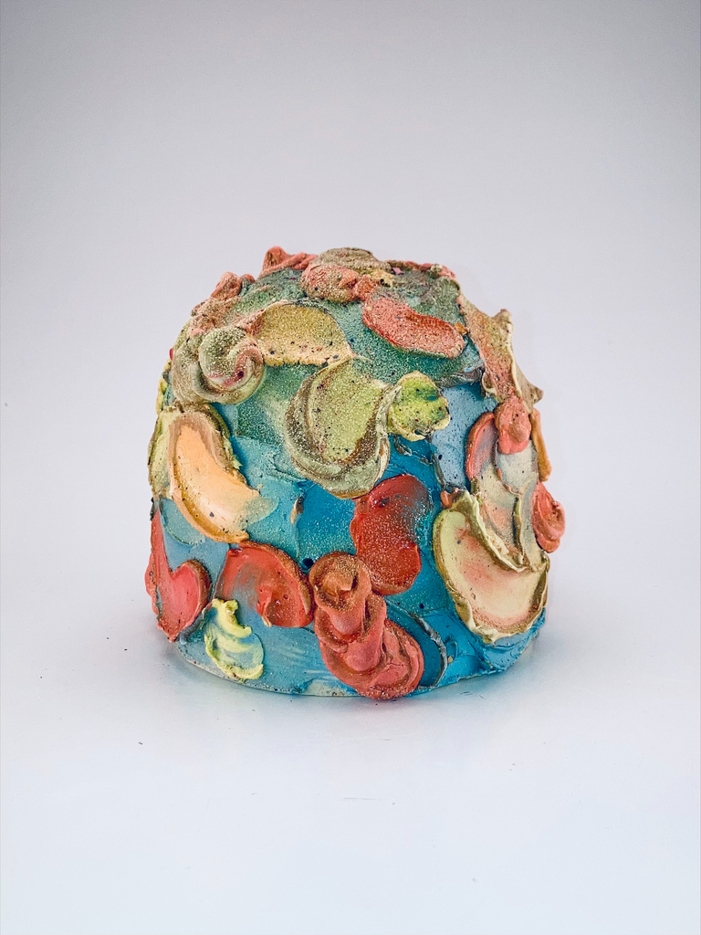 Alyson's work: a rounded blue, green, yellow, and red ceramic vessel.