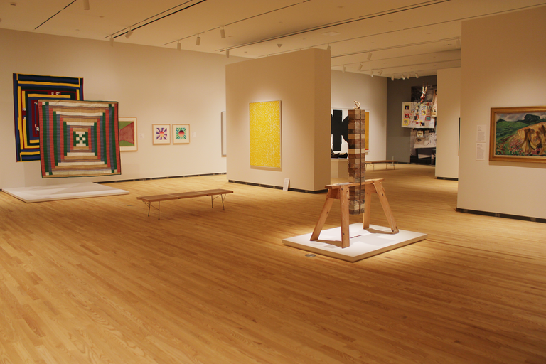 An installation shot of the galleries, featuring works by Charles Ray, Alma Thomas, and the Gee's Bend quilts.