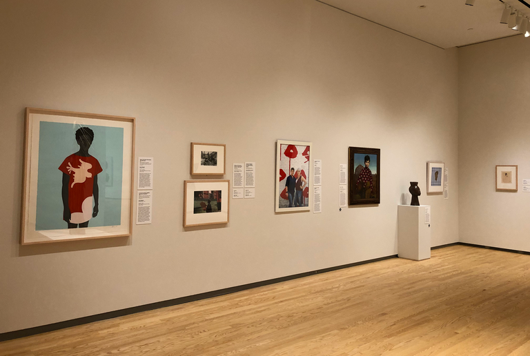 An installation shot of the galleries at the Stanley Museum of Art. Prominently featured are works by Amy Sherald, Grant Wood, and Simone Leigh.