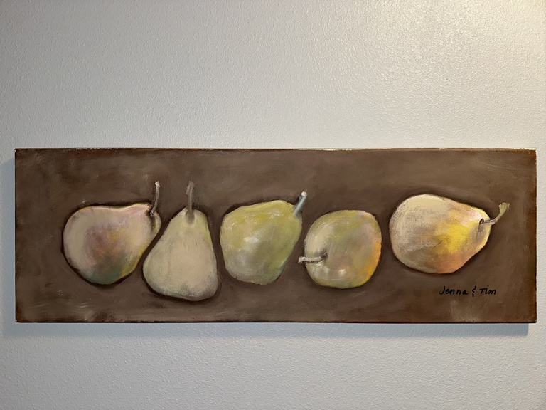 A photo of Jenna Mosnik's art: a long painting of pairs on a brown background.
