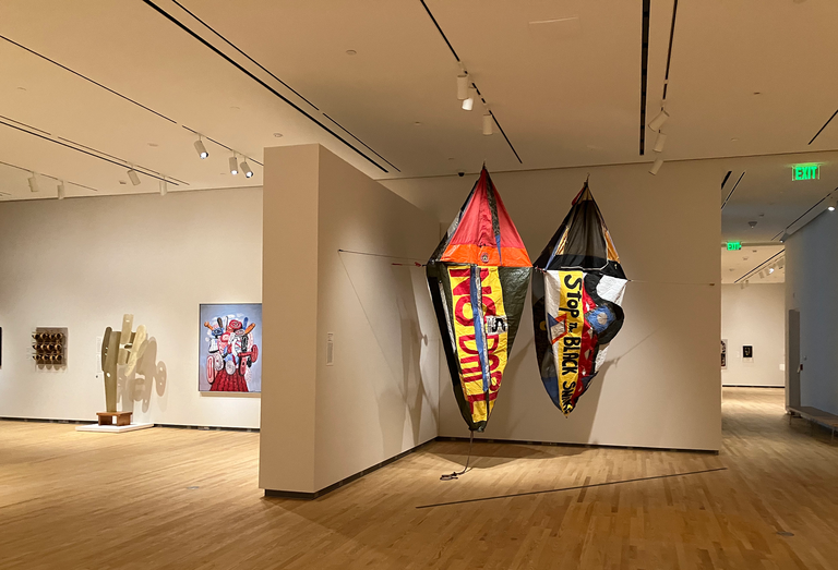 An installation shot of the galleries at the Stanley Museum of Art; featured prominently is a loan piece by Yatika Starr Fields, involving tents suspended from the ceiling. 