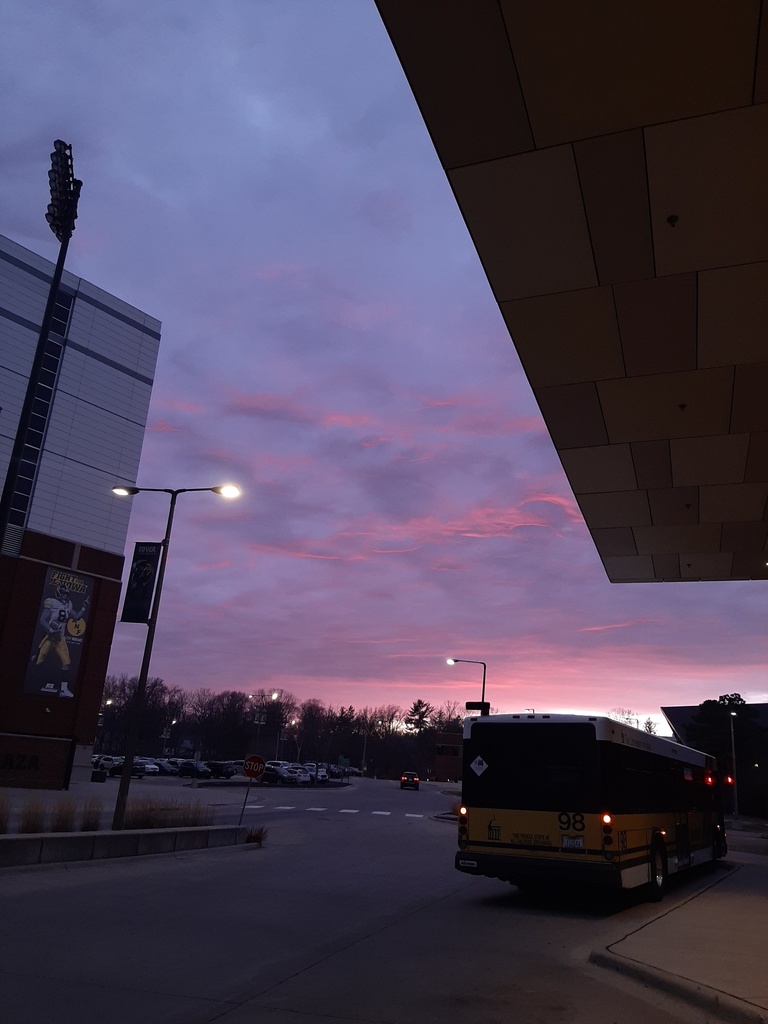 Zoe's art: a photo of the sky, pink and blue, from underneath a building overhang.