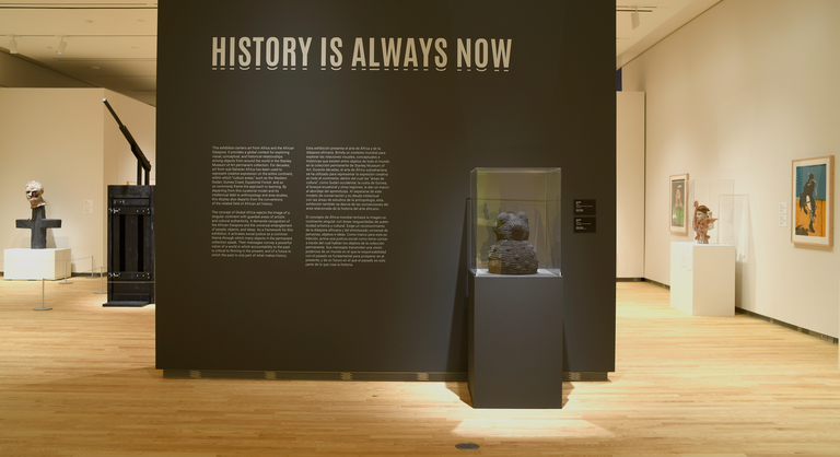 An installation shot of "History is Always Now," featuring a case with a sculpture by Donte Hayes inside.