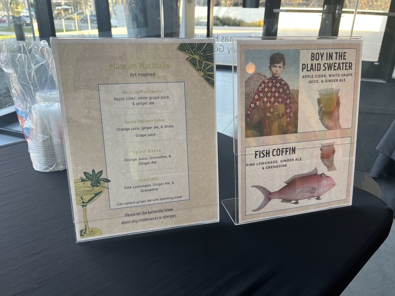display of written menu items available as a mocktail. these include plaid sweater, spring embraces yellow, spirit dance, and fish coffin. 