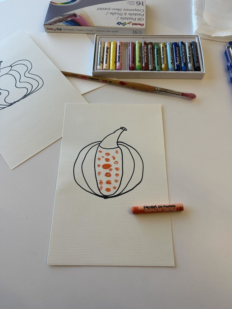 small orange circles drawn onto the pumpkin outline 
