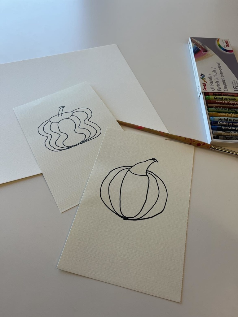 two abstract pumpkin outlines on white pieces of paper 