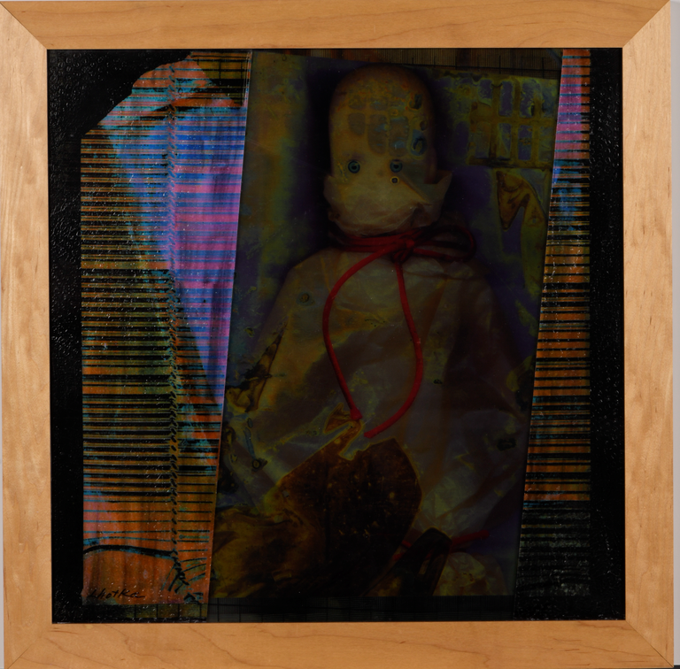 A doll-like figure wrapped in plastic, with a red cord tied around its neck, overlayed with abstract imagery