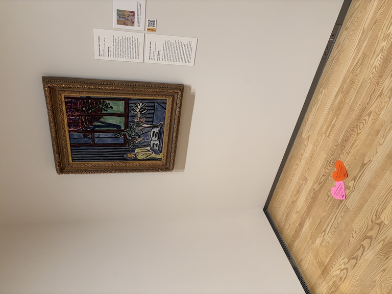 A photo of the galleries showcasing hearts on the floor in front of the Matisse painting.