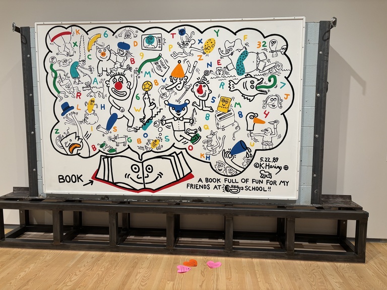 Hearts on the floor in front of Haring's "Book Full of Fun" mural.