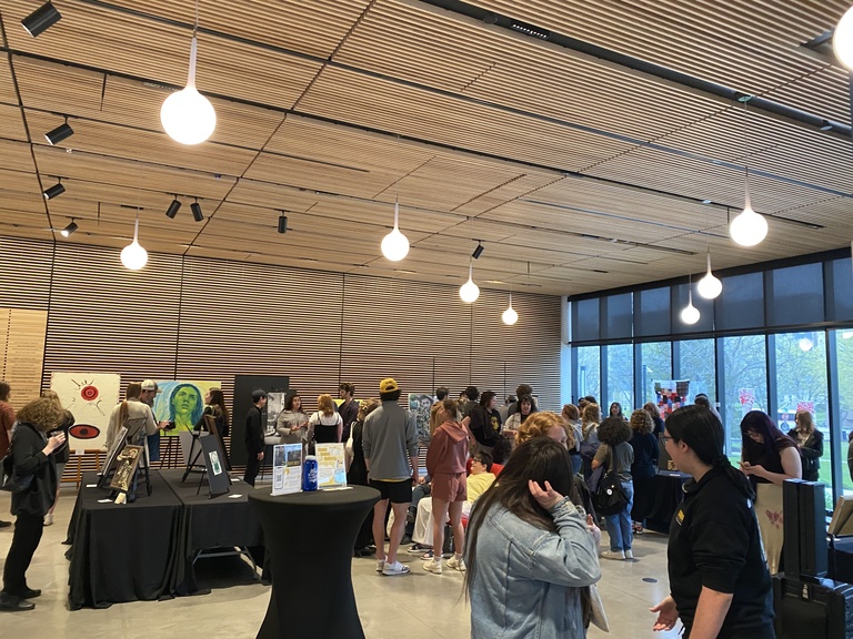 A photo of the SMA lobby, full of people during the Student Exhibit event.