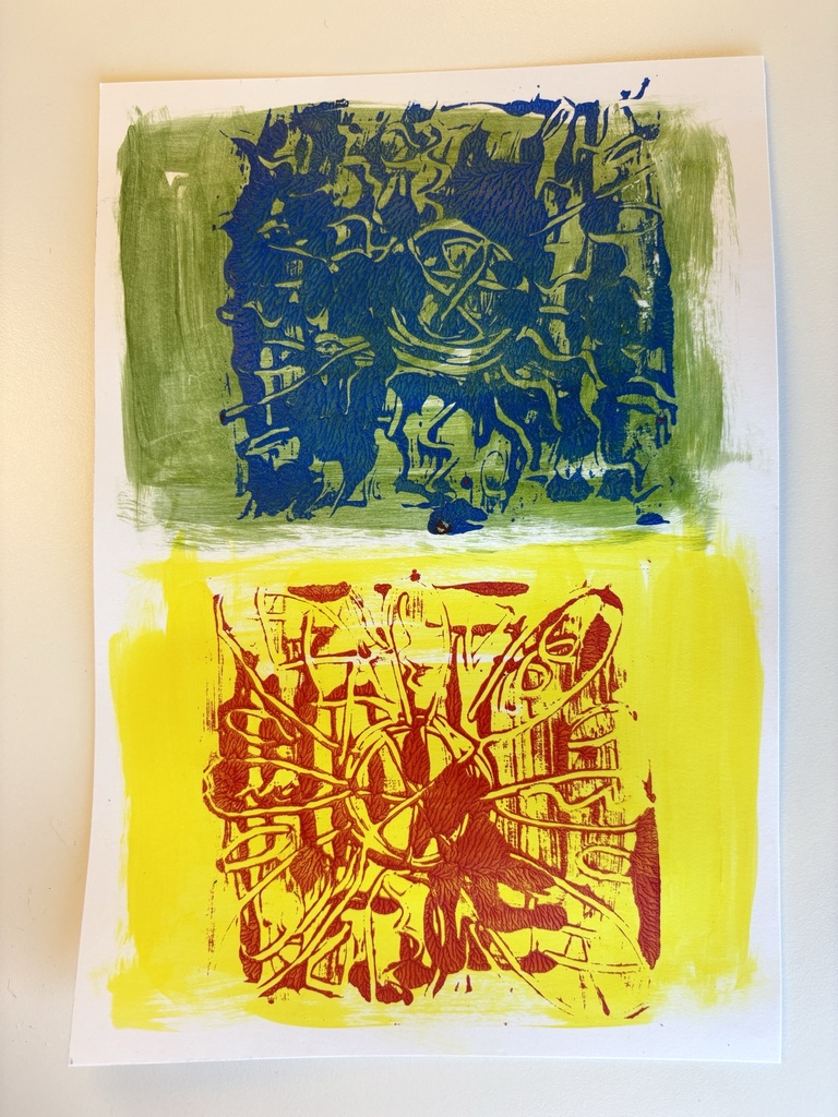 Examples of monoprints created with the kit; one blue and green and one red and yellow.