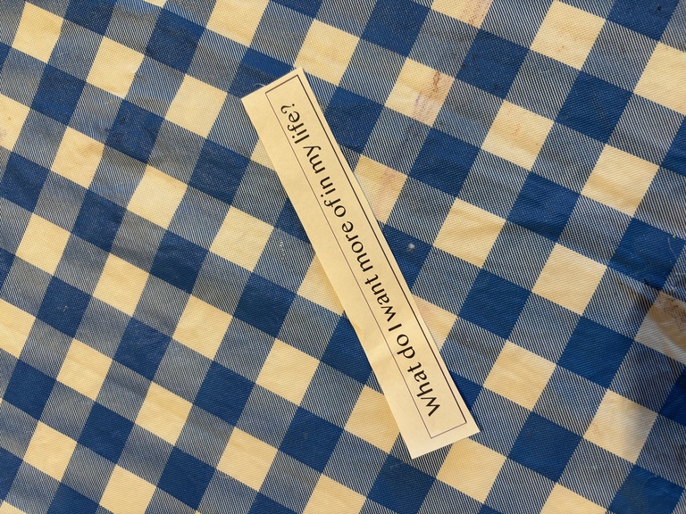 A slip of paper with a typed prompt that reads: "what do I want more of in my life?"