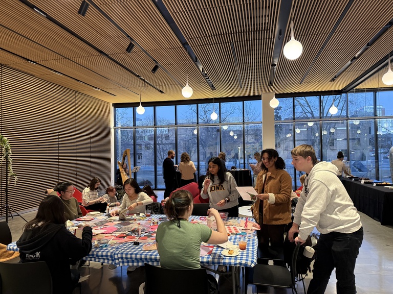 Students cluster around the valentine craft table