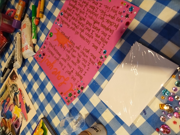 A photo of a craft someone was working on; an uplifting 'I love you' letter on pink paper. 
