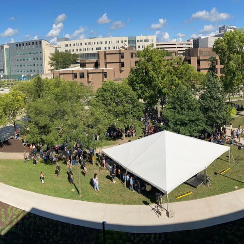 Aerial view of Gibson Square Park with large white tent and big crowd of people