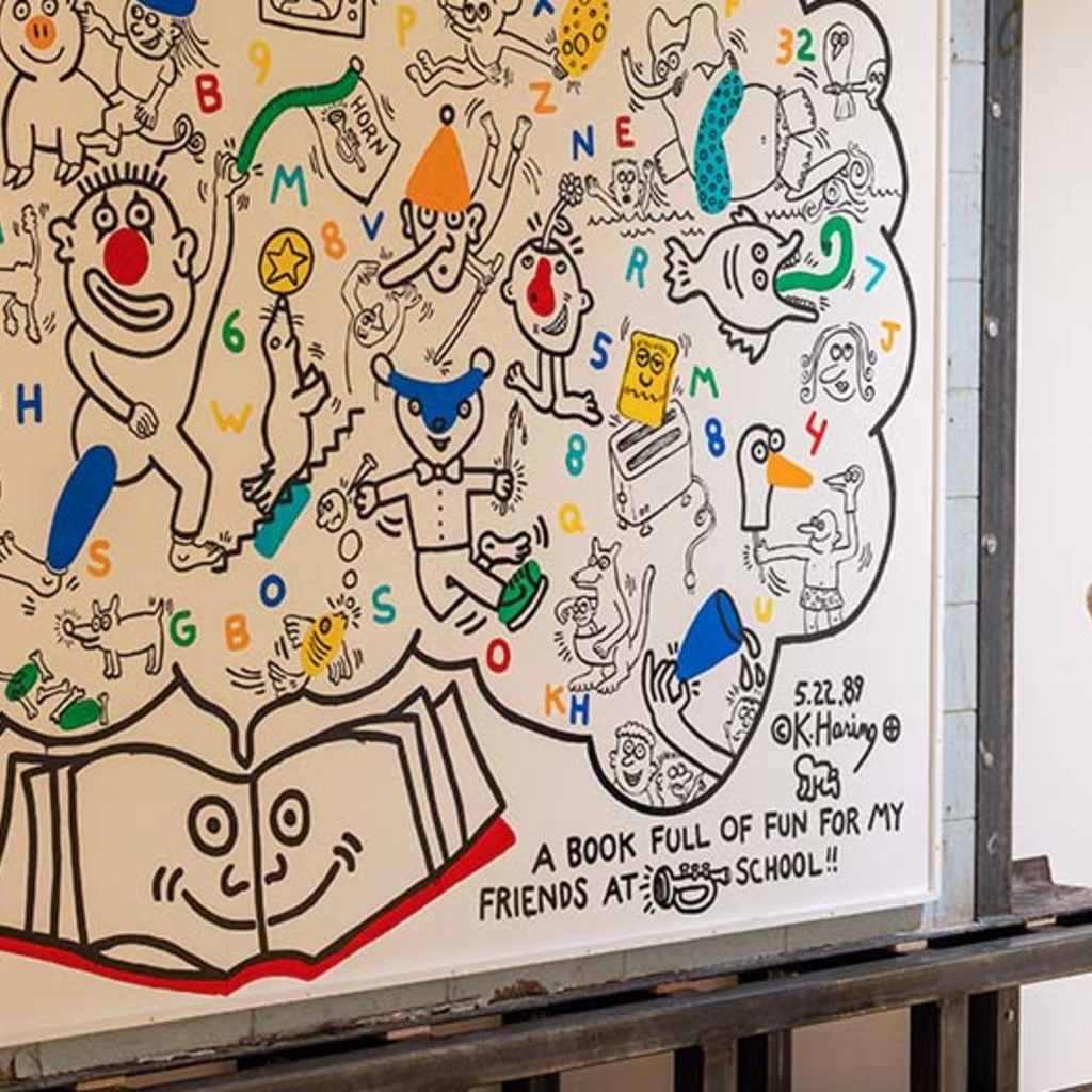 Ron Harvey, an art conservator with Tuckerbrook Conservation, assists with the installation of Keith Haring's A Book Full of Fun earlier this spring at the University of Iowa Stanley Museum of Art.
