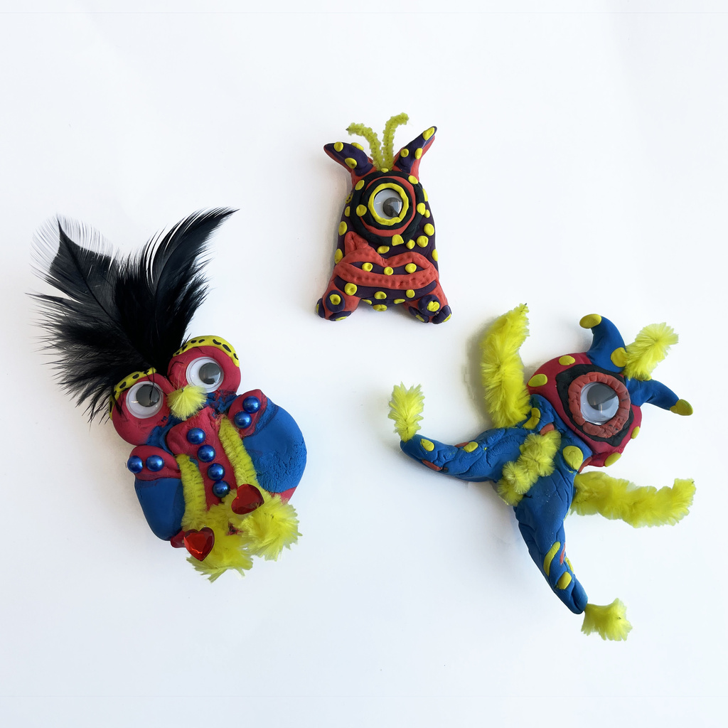 Colorful clay figurines with googly eyes and ebellishments