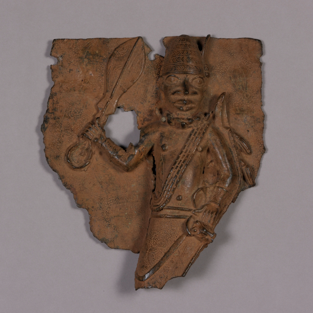 A bronze plaque depicting a figure