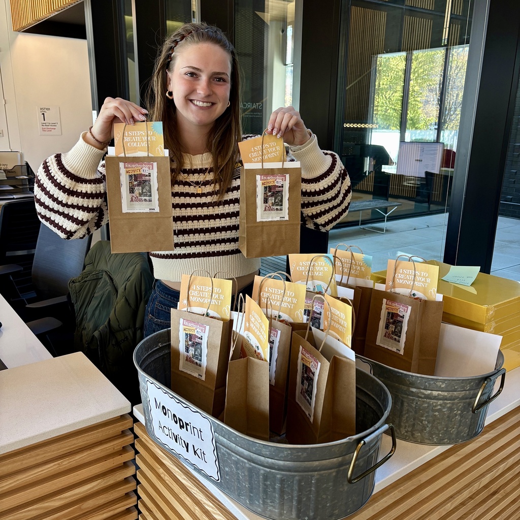 Amelia poses with the activity bags at the front desk.