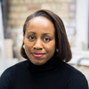 woman with chin-length dark hair wearing a dark turtleneck top