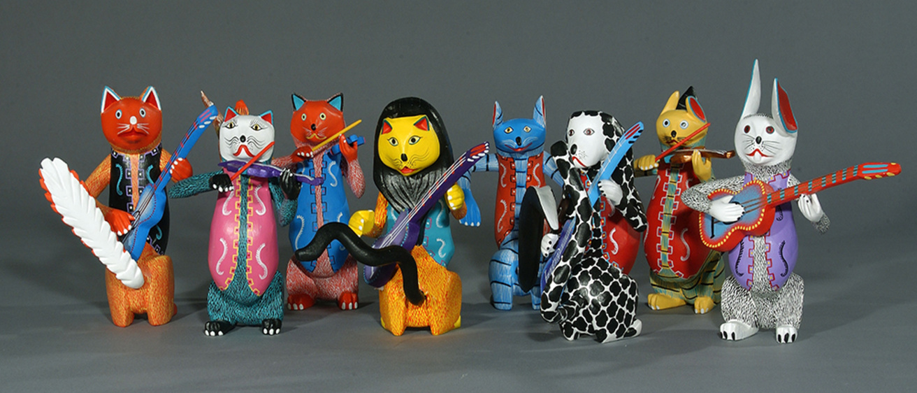 A group of eight brightly-painted, carved-wood animal musicians