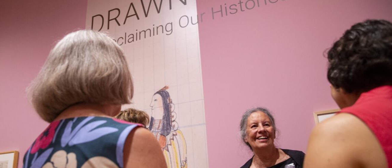 “Drawn Over” guest curator Jacki Thompson Rand smiles Aug. 24 as she talks with people about this newest exhibition at the Stanley Museum of Art in Iowa City. The exhibition runs through Jan. 2. The group shows the art and history the Indigenous Plains men who drew on pages ripped from government ledger books and given to them after they no longer had enough buffalo hides. (Savannah Blake/The Gazette)