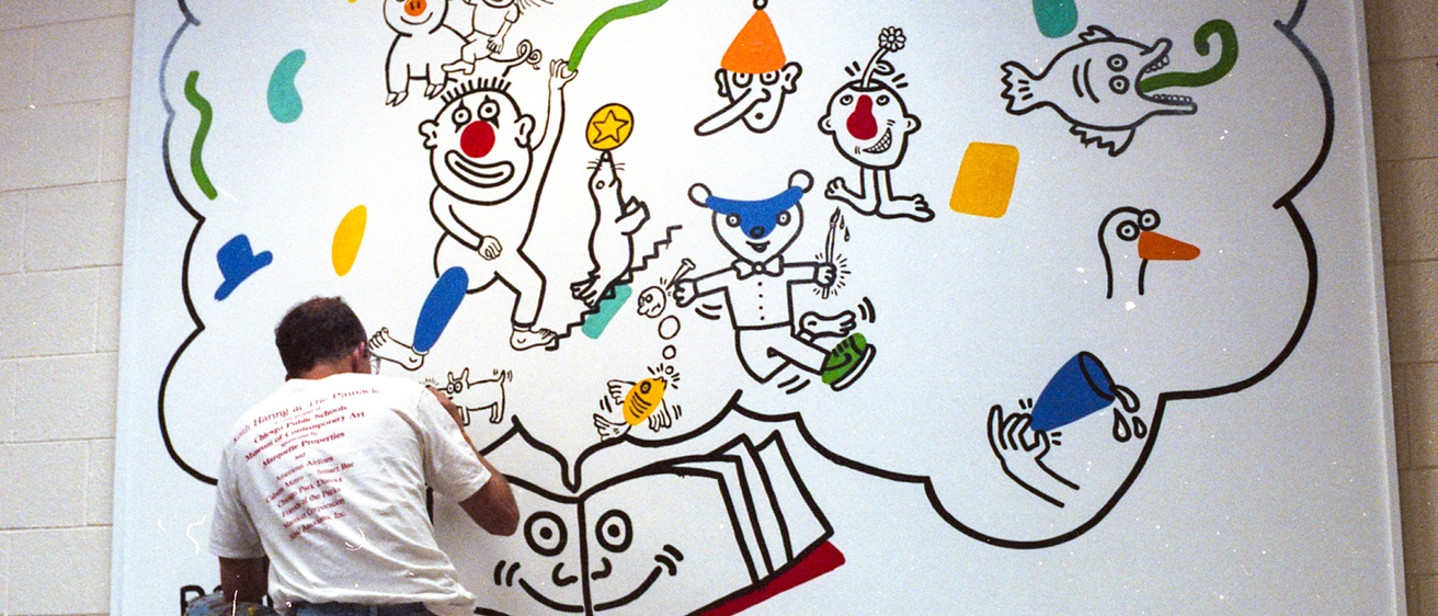 Keith Haring at work on the mural at Ernest Horn Elementary School