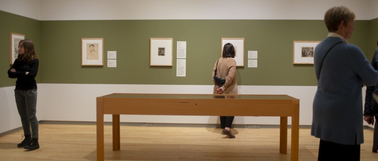 Attendees view the art of the grand opening of latest exhibition “A Year in Print” at the Stanley Museum of Art