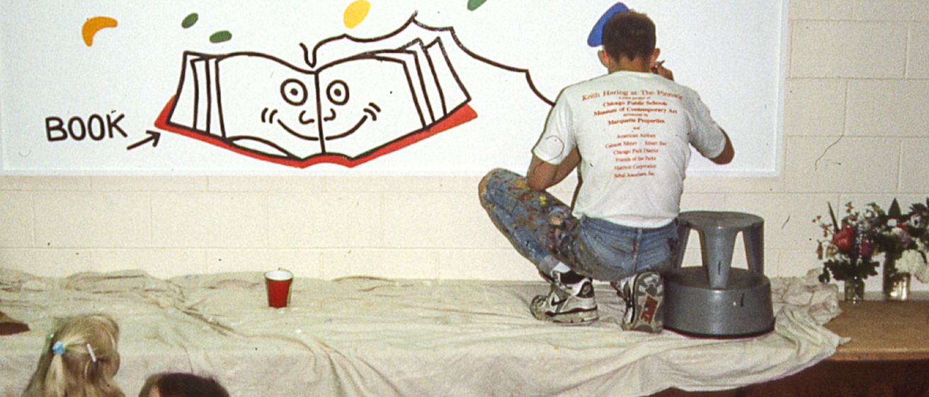 Keith Haring at work on the mural at Ernest Horn Elementary School, 1989. Photographer unknown. Image courtesy of Colleen Ernst. © Keith Haring Foundation.