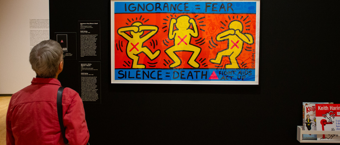 A person viewing framed art in a gallery
