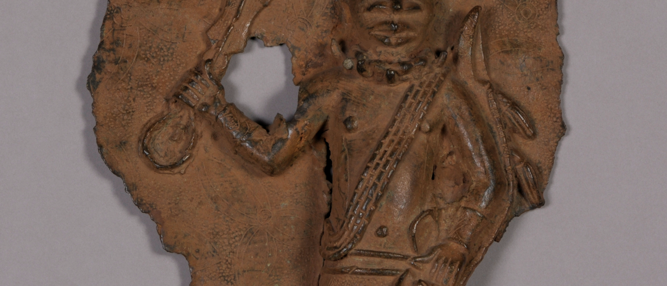 A bronze plaque depicting a figure